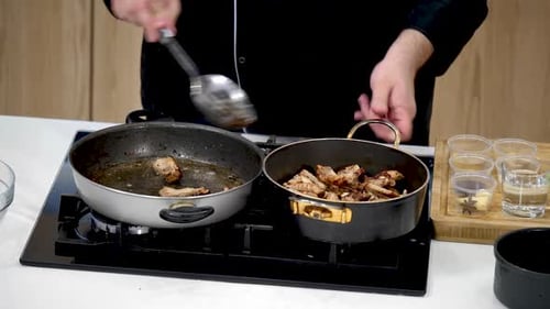 Chef Transfers Cooked Meat from Skillet to Pot