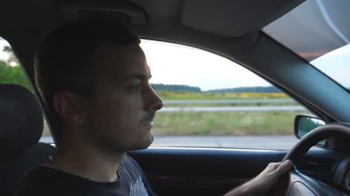 Man Driving Car on Rural Highway During Daytime