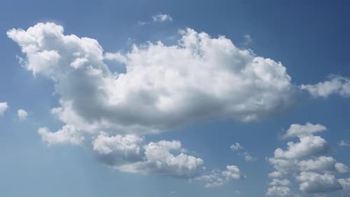 Fluffy White Clouds Drifting in a Blue Sky