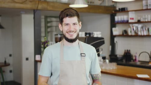 A Friendly Barista Stands Proudly in a Contemporary Cafe Showcasing Excellent Service and a Warm
