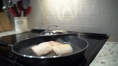 Fish Cooking in Frying Pan on Stovetop