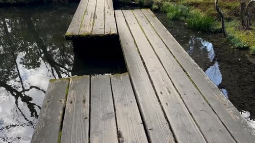 Wooden plank bridge at Tenjuan Buddhist Temple, Kyoto Japan.