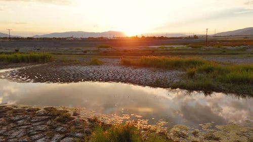 Vibrant Sunset Over Cracked Earth Landscape