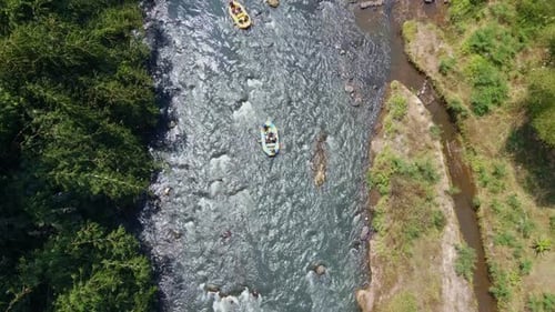 Overhead drone shot of rafting boat on the rocky river.