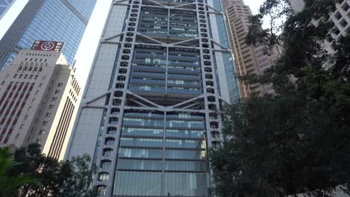 Panning up HSBC building and other bank tower skyscrapers in Hong Kong asian financial centre