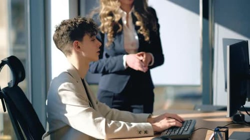 Two Young Adults Working in an Office