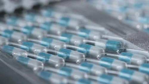 Pharmaceutical factory conveyor line filling sterile blister with medication pills