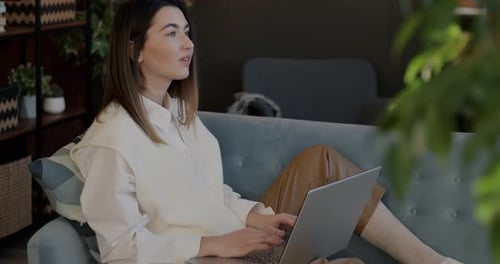 Woman Working on Laptop Computer at Home