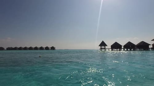 Bungalow huts on tropical resort beach a paradise vacation in maldives