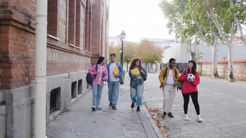 Education, group of students walk outside university or school campus.