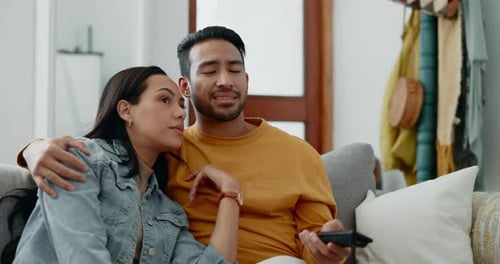 Relaxing Couple Laughing Together at Home on Couch