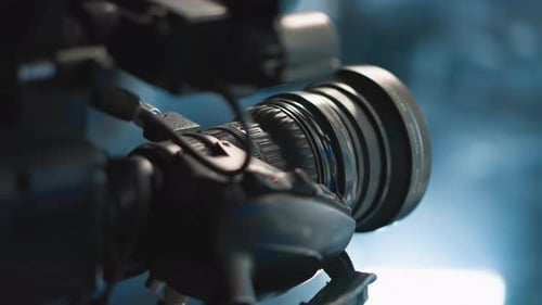 Close Up Camera Lens Reflecting Neon Studio Lights with Focus Ring Textures