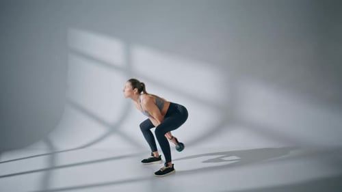 Strong Lady Lifting Kettlebell in Gym Healthy Woman Training with Heavy Weight