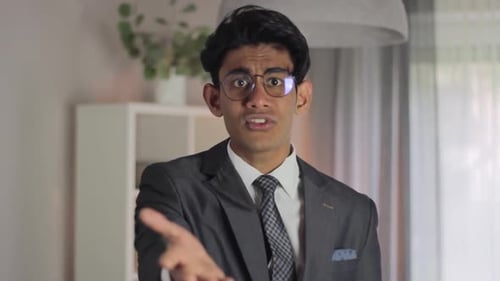 Expressive Young Adult in Suit Gesturing and Talking