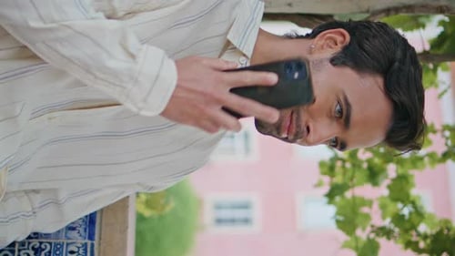 Happy Macho Calling Smartphone Waiting at Park Vertically Zoom on Man Talking