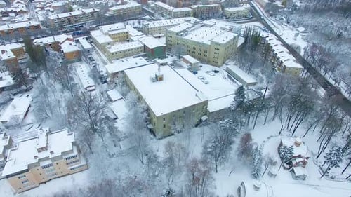 Beautiful view of the busy city on winter season. Building tops are covered with snow.