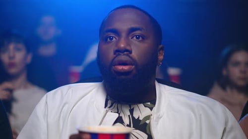 Portrait Of Shocked African Man Watching Horror Movie In Cinema. Closeup Terrified Afro Male Pers...