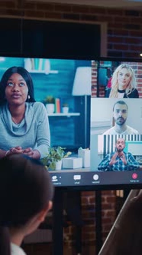 Women Watching Video Conference in Modern Office