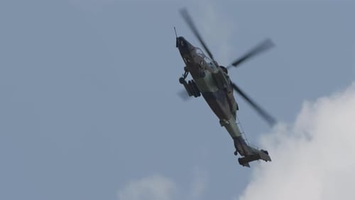 Military Helicopter Flying in Cloudy Sky