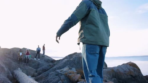 Friends Walking on Coastal Rocks and Balancing on Log