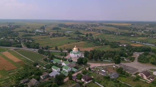 Drone Flies Over Small Church in European Village