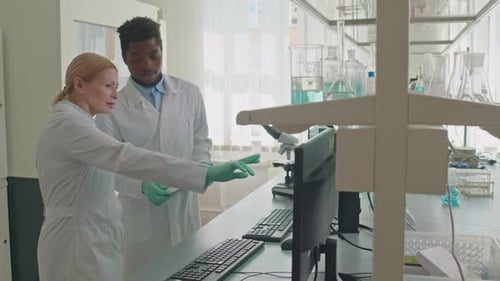 Multiracial Couple of Lab Scientists Talking at Workplace