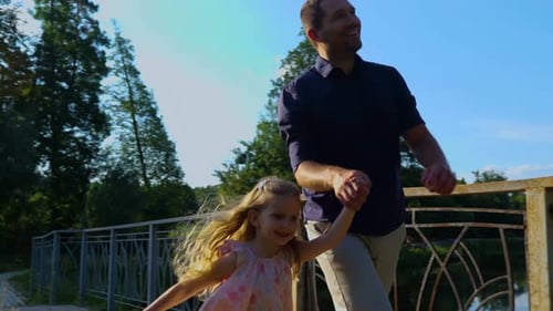 Family Runs Through Park with Kite in Summertime