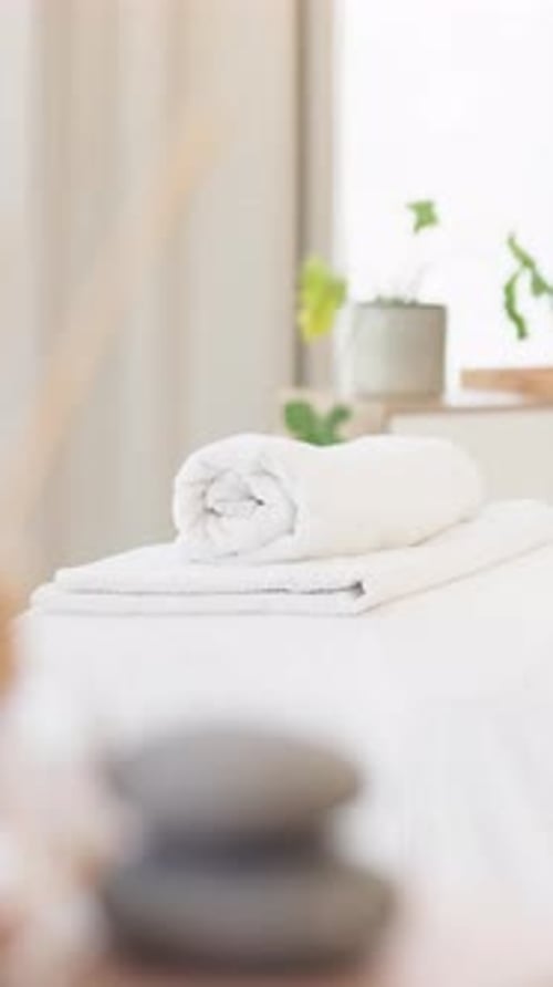 Spa, massage table and towel in hotel for wellness, luxury treatment and peaceful hospitality