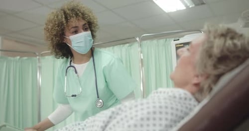 Female Nurse in Hospital Examining Patient wearing Face Mask