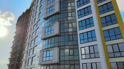 High Residential Apartment Building with Monolithic Frame and Glass Windows Under Construction Real