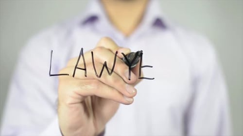 Hand Writes the Word Lawyer on Glass