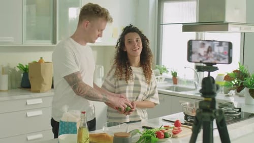 Gen Z Couple Filming Culinary Masterclass with Phone in Kitchen