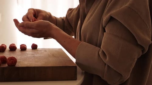 Woman Forms Tasty Meatballs in Bright Home Kitchen