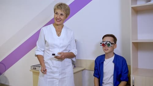 Portrait of a kid boy wearing corrective glasses with replaceable lenses. Ophthalmology clinic.