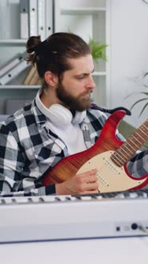 Man Plays Electric Guitar in Home Studio