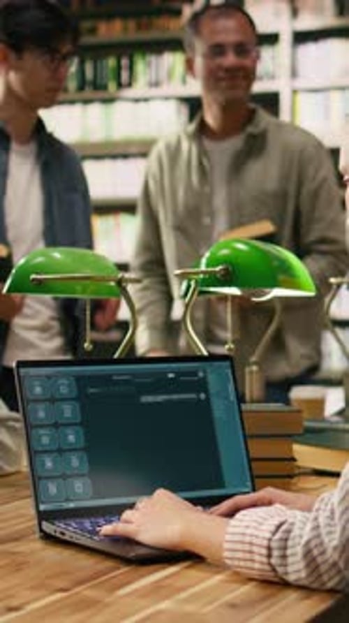 Vertical Video Student Uses Laptop with AI Chatbot Interface at Library Table