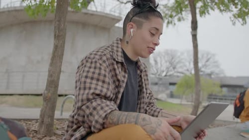Young Girl Chatting on Video Call on Laptop Outdoors on Street Bench