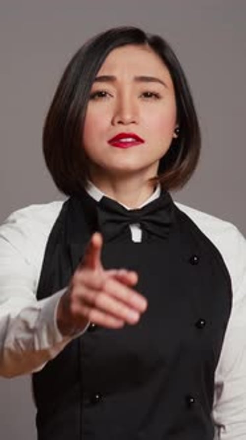 Vertical Video Restaurant Hostess Showing Silence Symbol in Studio