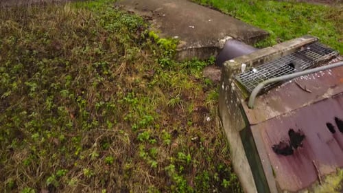 Water pollution, factory sewage water flowing out on river from rusty pipeline - dolly backward tilt