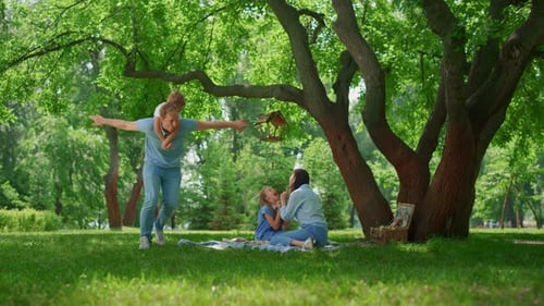 Happy family spending time at a park picnic