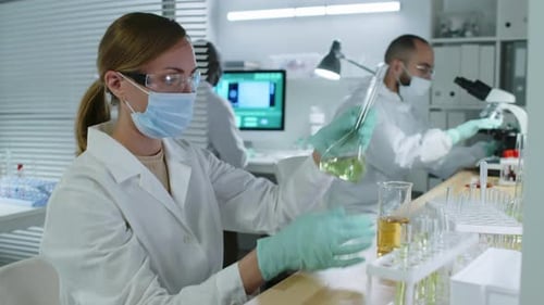 Scientist Examining Solutions in a Modern Laboratory