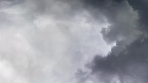 aerial view of crossing thunderstorms occur in dark skies.