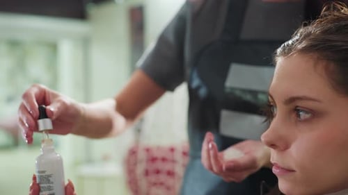 Woman Getting Hair Treatment at Salon with Serum