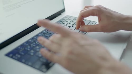 Hands Typing on Laptop Keyboard Close Up