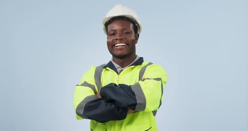 Happy black man, engineer and arms crossed of professional in construction on a studio blue