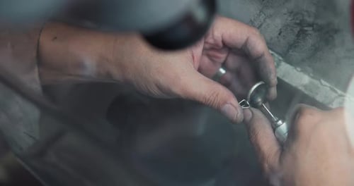 Jeweler Polishes a Ring During the Making Process in a Workshop