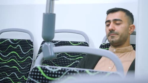 Man Using Smartphone on Public Bus