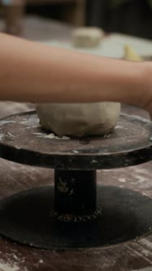 Hands Forming Clay Pot on Wheel