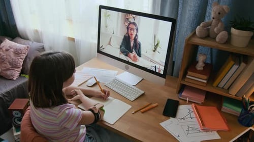 Teen Girl Writing in Copybook Studying Online with Female School Teacher