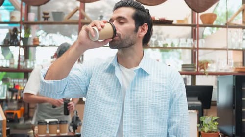 Smiling Man Drinking Coffee in Cafe
